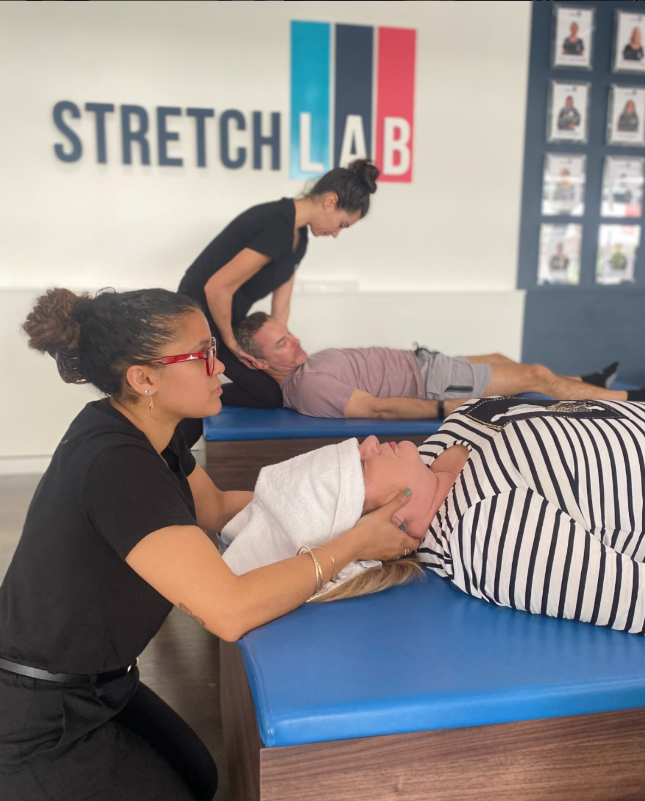 Woman receiving an assisted stretching session to improve mobility and reduce tension